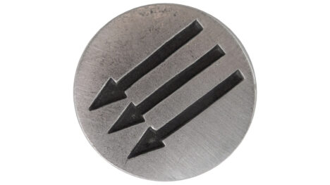 Photo of round pewter pin silhouetted against a white background. Pin is medium silver gray, slightly weathered, and has three parallel black arrows debossed across it. Arrows are pointing down and to the left at a 45-degree angle.